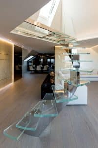 Central spine staircase with glass treads