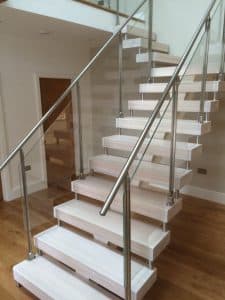 Central Spine staircase White treads with stainless steel and glass balustrade