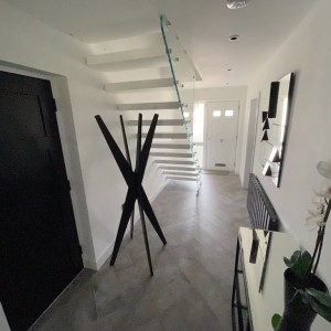 White floating staircase with frameless glass balustrade White floating staircase with frameless glass balustrade