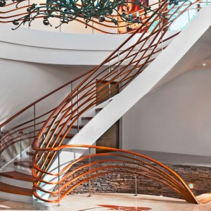 Helical closed rise stair with wave styled oak balustrades Helical closed rise stair with wave styled oak balustrades