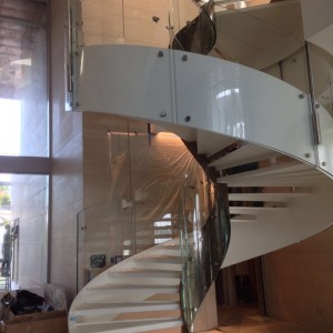 Helical spiral staircase with helical centre and frameless glass balustrades Helical spiral staircase with helical centre and frameless glass balustrades