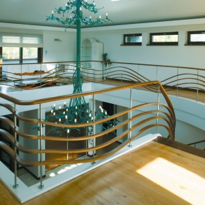 Hand formed balustrades curved oak bands set with feature stainless steel post and a matching oak handrail Hand formed balustrades curved oak bands set with feature stainless steel post and a matching oak handrail