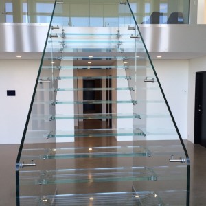 Open rise glass staircase with ultra clear balustrades self supporting between ground and 1st floors Open rise glass staircase