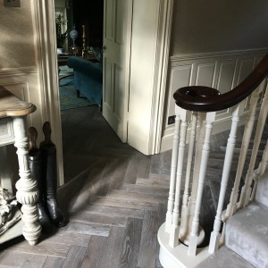 Grey parquet herringbone flooring