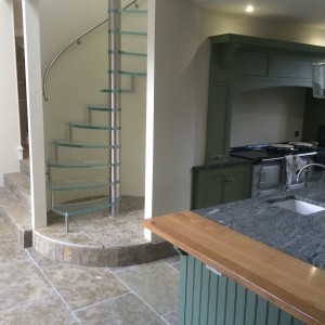 Feature glass spiral stair inset within a curved wall Feature glass spiral stair inset within a curved wall