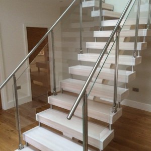 Central Spine staircase White treads with stainless steel and glass balustrade Central Spine staircase White treads with stainless steel and glass balustrade