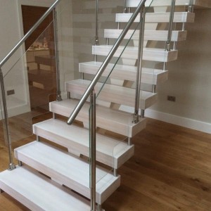 Central spine staircase with glass and stainless steel balustrade and chunky treads