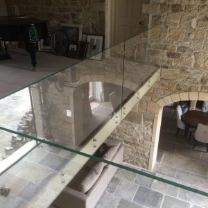 Frameless glass balcony balustrade face fixed with bespoke stainless steel fixings Frameless glass balcony balustrade face fixed with bespoke stainless steel fixings