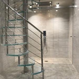 Glass spiral stair with anti slip treads and stainless steel features Glass spiral stair with anti slip treads and stainless steel features