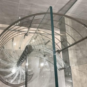 Glass spiral stair giving access between shower and bath Glass spiral stair giving access between shower and bath