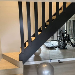 Contemporary closed riser stair with steel strings and steel feature slates Contemporary closed riser stair with steel strings and steel feature slates