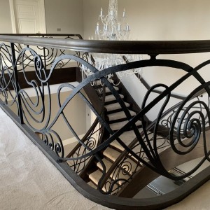 Bespoke hand forged iron balustrades with dark Oak handrails Bespoke hand forged iron balustrades with dark Oak handrails