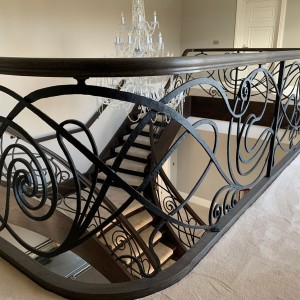 Bespoke iron balustrade hand forged with matching oak features and handrail Bespoke iron balustrade hand forged with matching oak features and handrail